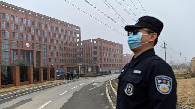 An officer stands guard as members of the World Health Organisation (WHO) team investigating the origins of Covid-19 make a visit to the Wuhan Institute of Virology in Wuhan in 2021.