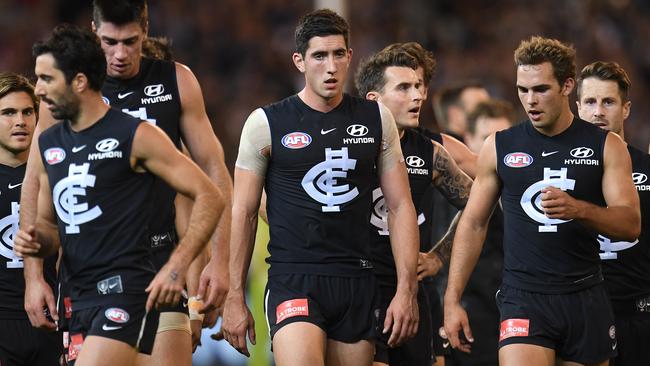 Jacob Weitering leads Carlton off at half-time.