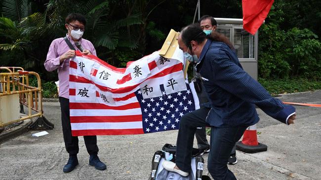 A pro-Beijing protester stamps on an image depicting US House Speaker Nancy Pelosi at a protest outside the US Consulate in Hong Kong. Picture: AFP