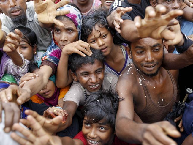 Refugees fight to be at the front of the aid queue at a refugee camp in Bangladesh. Picture: K.M. Asad