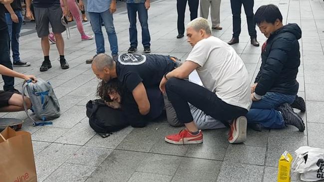 Siecker was pinned down by Rundle Mall pedestrians after he attacked Mr Eberhart. Picture: Shaun Hollis.