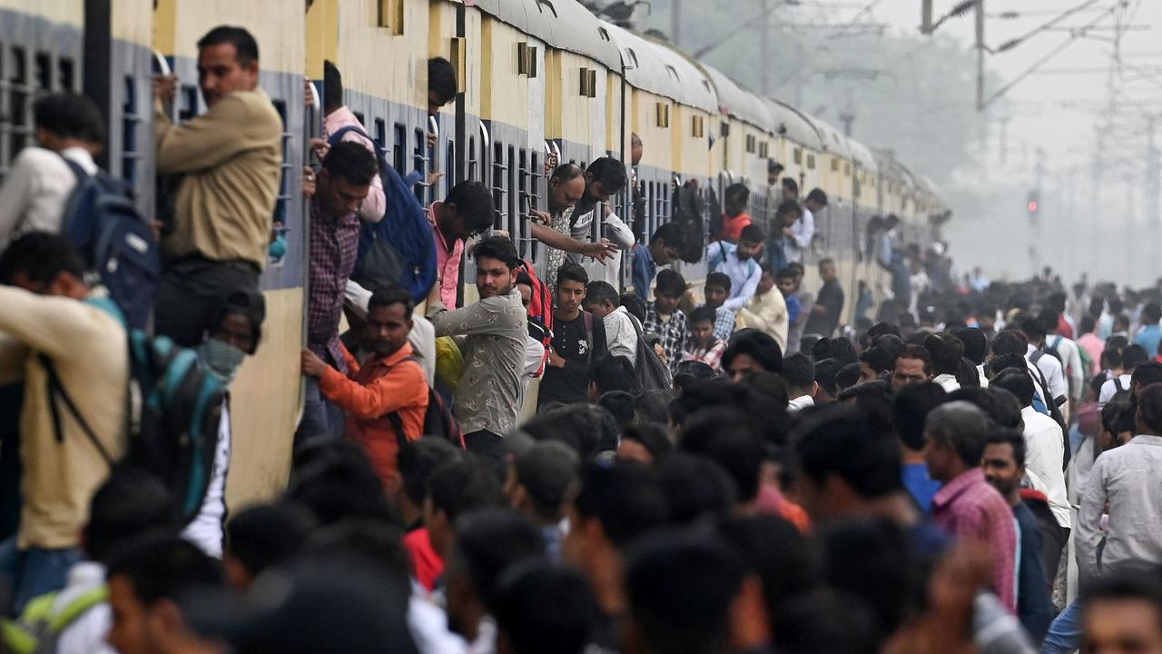 Commuters travel on an overcrowded train near Loni town in India, which has just recorded the world’s largest population. Picture: AFP
