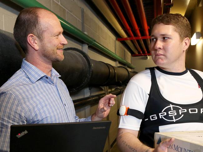 Scott Coleman with Aon employee Cameron O'Connor wearing a workplace health monitoring system. Scott is a sports scientist who works for Aon Hewitt and is designing workplace health programs using wearable monitoring devices.