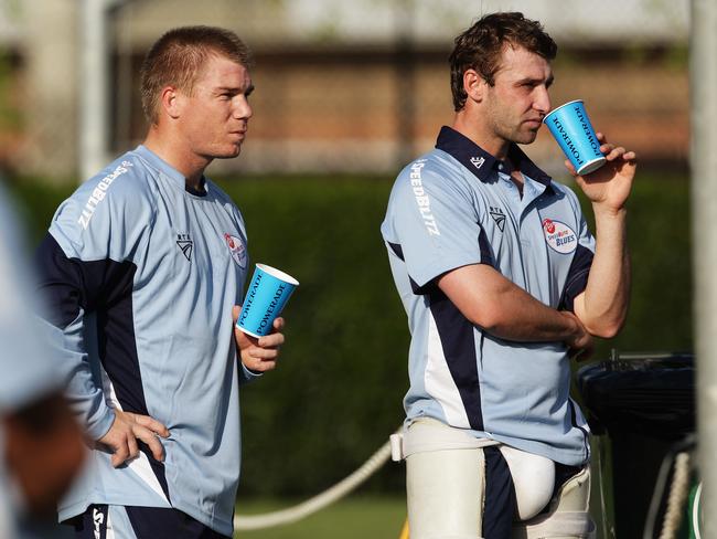 David Warner (L) and Phillip Hughes look on during NSW net practice early in their careers.