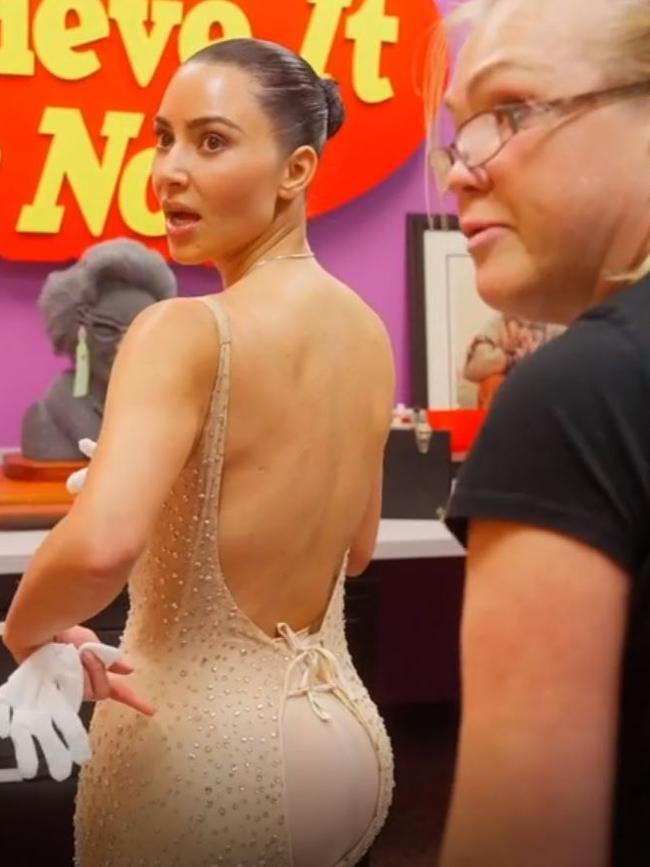 The dress gapes open over Kim’s backside.