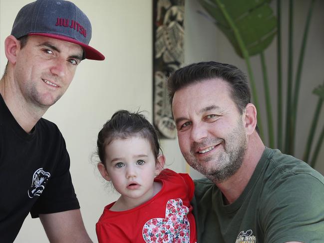 Pictured in Illawong is Joel Chapman with his brother in law Michael Zirps and Michaels daughter Ella.Joel and Michael performed CPR on Ella after she fell in their backyard pool as a toddler.Picture: Richard Dobson