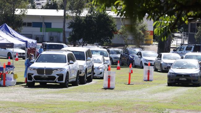 People queue for Covid testing at Indooroopilly State High School. Picture: Annette Dew