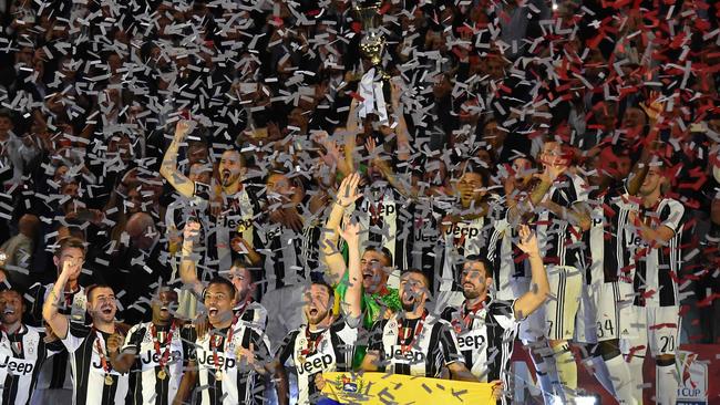Juventus' players celebrate with the trophy after winning the Italian Cup.