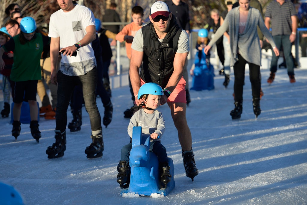 Darren Ingram gives his nephew Leo Giuffrida a push ice skating at Winter Wonderland in the Civic Square, Friday, June 22, 2018. Picture: Kevin Farmer