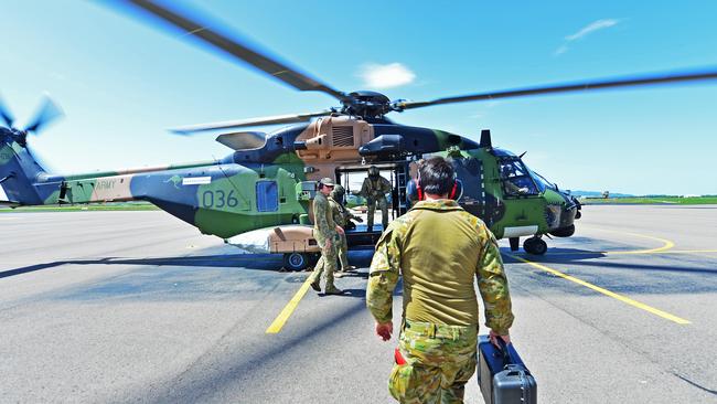 Members from 5th Aviation Regiment get on board a MRH-90 Taipan as the Army drops off supplies to farmers who were affected by the floods. Picture: Zak Simmonds