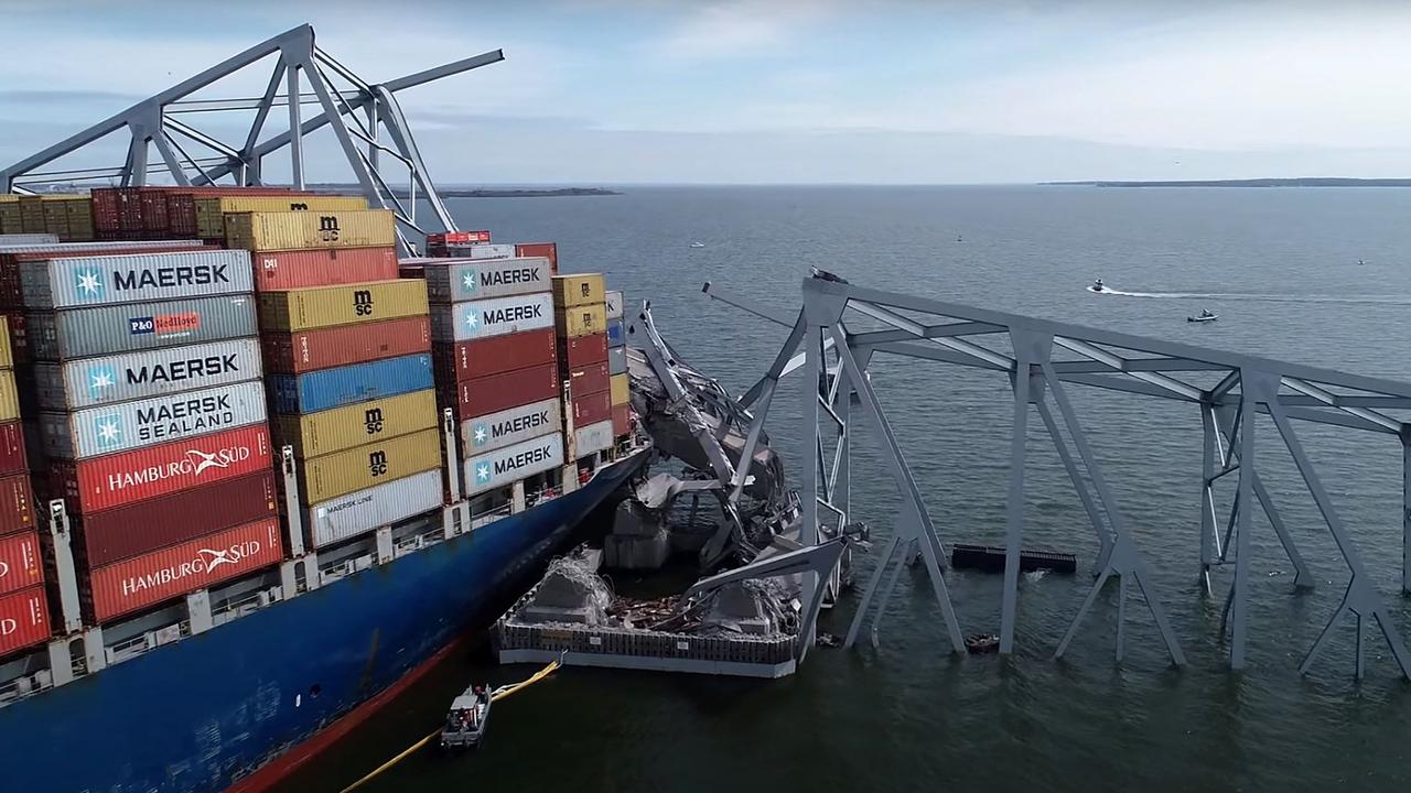 The steel frame of the Francis Scott Key Bridge sitting on top of the container ship Dali. (Photo by National Transportation Safety Board / Youtube / AFP)