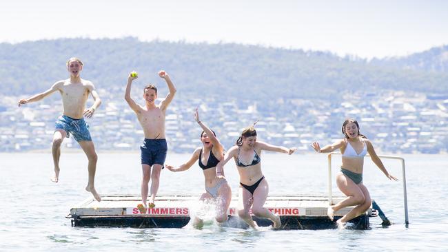 Charlie Rockefeller, Ruben Hoey, Kenita Aitken, Bessie Harman and Libby Watts enjoy a dip at the pontoon on Long Beach, Sandy Bay. Picture: RICHARD JUPE