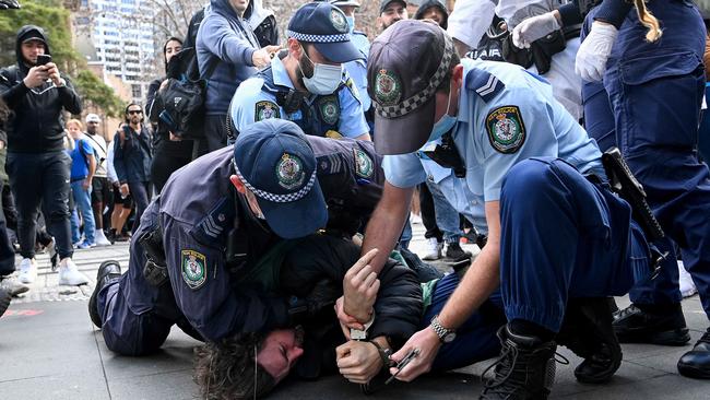 A protester is handcuffed by police. Picture: NCA NewsWire/Bianca De Marchi