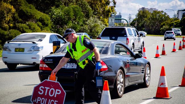 Police manning a vehicle checkpoint on the Pacific Highway at the Queensland-New South Wales state border near Coolangatta. Picture: AFP.