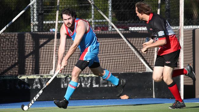 Saints' Darryn Born gets past Souths veteran Gary Whipp in the Cairns Hockey senior men's match between South Cairns and Cairns Saints. PICTURE: BRENDAN RADKE