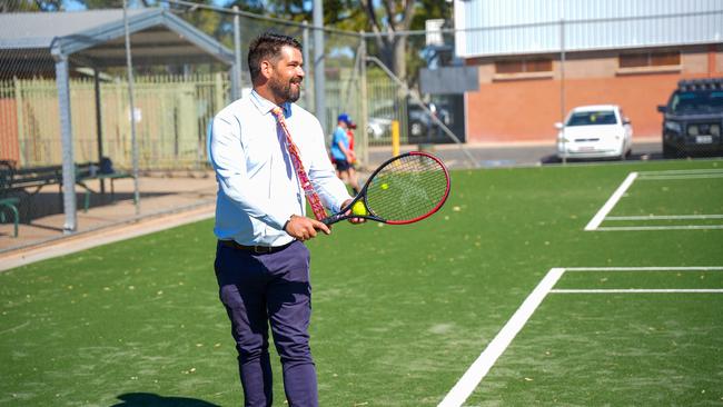 Alice Springs Town Council Mayor Matt Paterson has a swing on the recently completed courts. Picture: Alice Springs Town Council