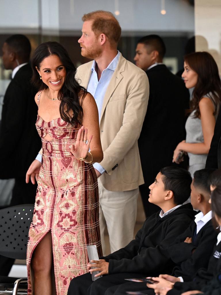 Ms Markle ‘soaks up all the attention’ as Prince Harry trails behind her, according to body language experts. Picture: AFP