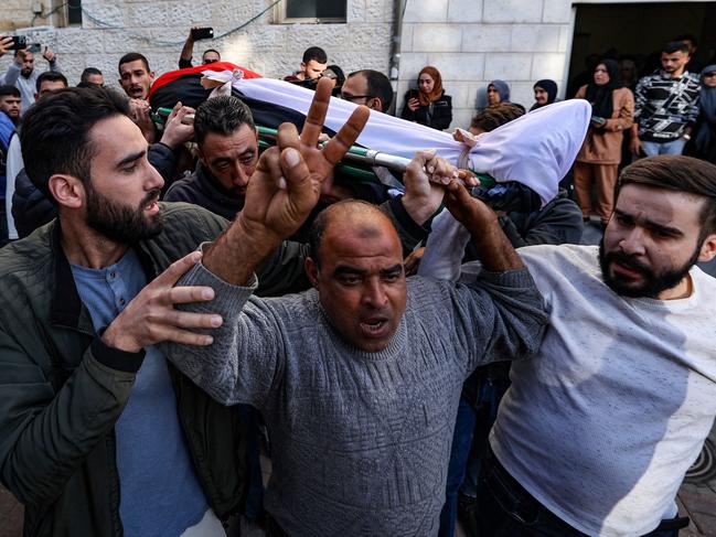 Mourners carry the flag-draped body of Ali Alwan, killed in an Israeli raid in the town of Burqah near the occupied West Bank city of Ramallah. Picture: AFP