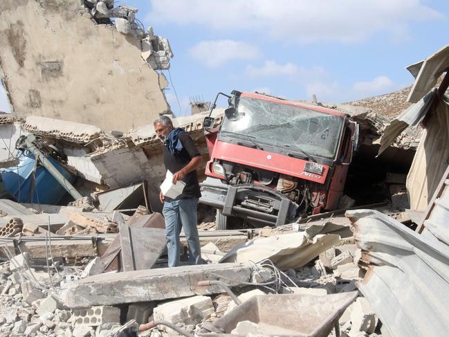 A man inspects the damage to a building after an Israeli strike in the southern town of Kfour, in the Nabatiyeh district, on August 17, 2024, amid the ongoing cross-border clashes between Israeli troops and Hezbollah fighters. Lebanon's health ministry said an Israeli air strike in southern Lebanon killed 10 people including children. It was one of the largest tolls in southern Lebanon since the Iran-backed Hezbollah movement and Israeli forces began exchanging near-daily fire over their border after war in the Gaza Strip began in October. (Photo by Mahmoud ZAYYAT / AFP)