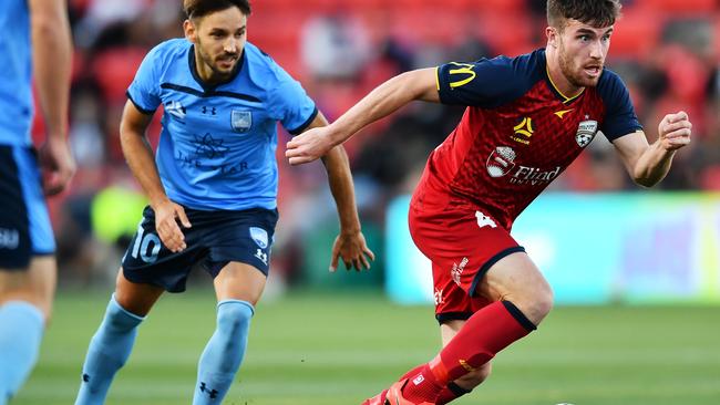 ADELAIDE, AUSTRALIA - MARCH 28:  Ryan Strain of Adelaide United gets a way from Milos Ninkovic of Sydney FC during the A-League match between Adelaide United and Sydney FC at Coopers Stadium, on March 28, 2021, in Adelaide, Australia. (Photo by Mark Brake/Getty Images)