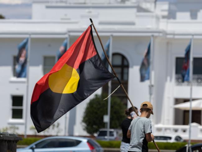 CANBERRA, AUSTRALIA - NewsWire Photos JANUARY 26, 2023: A small crowd gathered at the Aboriginal Tent Embassy, on the lawns of Old Parliament House, in Canberra to mark Invasion day. Ngunnawal boy, Tahlen Bell, 12 yers old, from Yass with the indigenous flag.Picture: NCA NewsWire / Gary Ramage