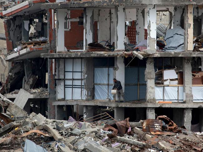 A Palestinian man clears debris in Jabalia in the northern Gaza Strip. Picture: AFP