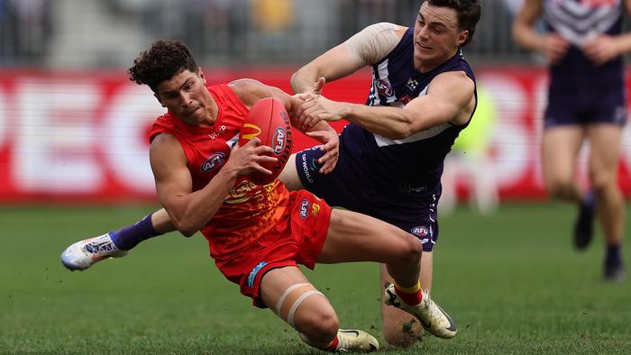PERTH, AUSTRALIA - JUNE 23: Jordan Clark of the Dockers tackles Jake Rogers of the Suns during the round 15 AFL match between Fremantle Dockers and Gold Coast Suns at Optus Stadium, on June 23, 2024, in Perth, Australia. (Photo by Paul Kane/Getty Images)