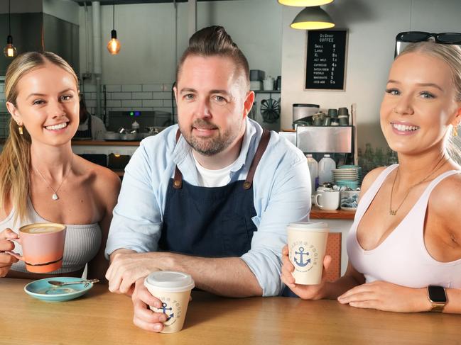 Coffee prices are going up due to increases in the price of Beans etc for cafes. Ben Nash, owner of Seafaring Fools on the Broadway at Glenelg, discussing beans with Sarah Ford (L) and Rachel Thomson (R). 9 January 2025. Picture: Dean Martin