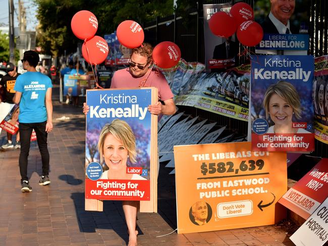 Volunteers pack away banners for Labor MP Kristina Keneally after voting ended.