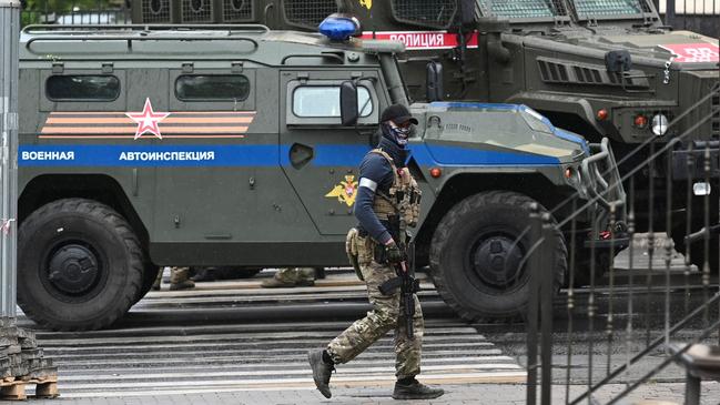 A fighter of the Wagner private mercenary group patrols a street near the headquarters of the southern military district in the city of Rostov-on-Don. Picture: Reuters