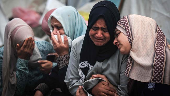 Palestinians mourn their relatives, killed in an overnight Israeli strike on the Al-Maghazi refugee camp, during a mass funeral at the Al-Aqsa hospital in Deir Al-Balah, in the southern Gaza Strip, on December 25, 2023, amid ongoing battles between Israel and the Palestinian militant group Hamas. Picture: Hahmud Hams/AFP