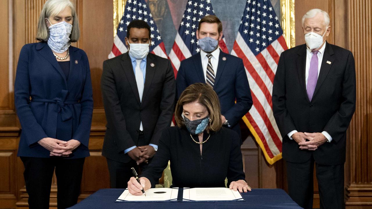 Speaker of the House Nancy Pelosi signs an article of impeachment against President Donald Trump. Picture: Stefani Reynolds/Getty Images/AFP