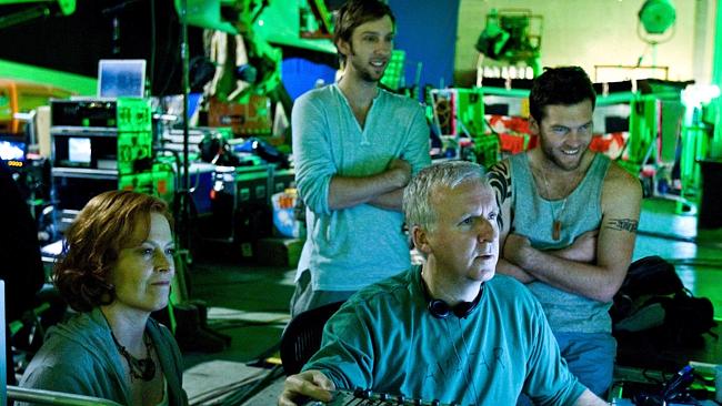 James Cameron reviews a scene with actors Sigourney Weaver, Joel David Moore and Sam Worthington during the filming of, 'Avatar'.