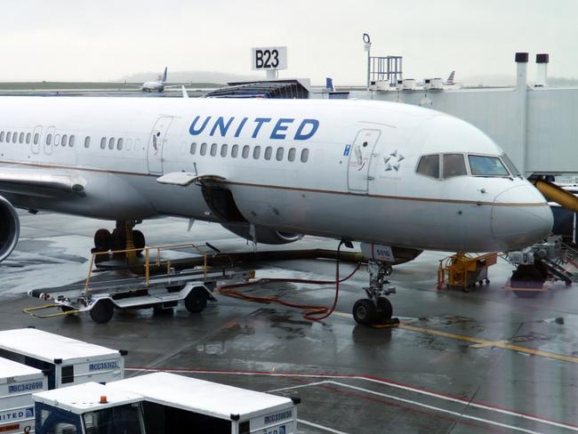 An United Airlines plane is parked at the gate on April 23, 2019, at Boston Logan International Airport. (Photo by Daniel SLIM / AFP)