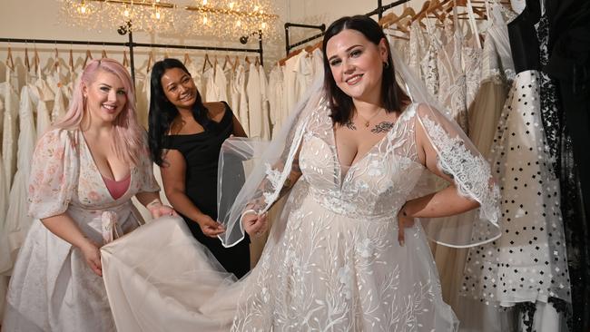 Curve Bridal has just launched Adelaide's only dedicated plus-size wedding boutique – it stocks sizes 16 to 30. Stylist Jasmine Norman, co-owner and designer Sok Hoffmann and bride-to-be Jessica Styles in the boutique. Picture: Keryn Stevens