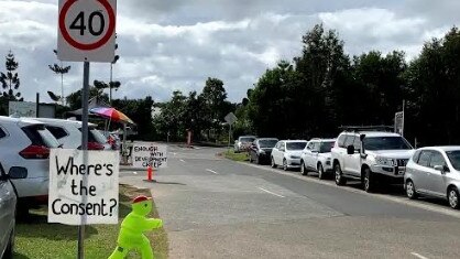 Signs at the Ecovillage at Currumbin on the Gold Coast where residents oppose a shopping centre development.