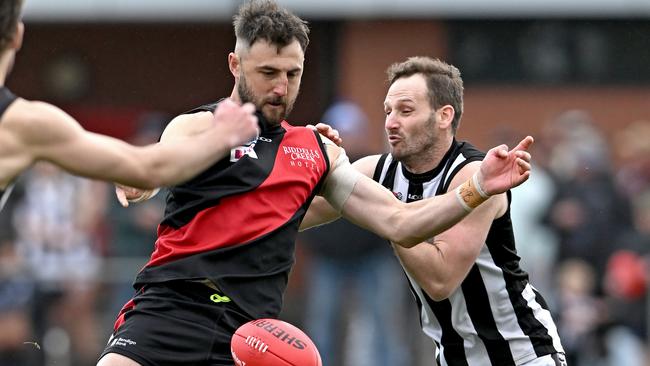 Riddell’s Dylan Tarczon under pressure from Wallan’s Steve Boyall. Picture: Andy Brownbill