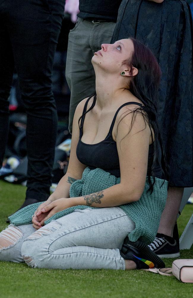 Kelly Wilkinson’s sister Natalie takes a moment during a vigil in Queensland this month. Picture: Jerad Williams