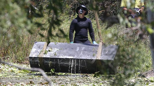 Police retrieve a large metal toolbox from a dam near Scrubby Creek, Kingston, four years ago. Picture: Jono Searle