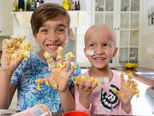 Levi and Madison O'Donohue making biscuits in the kitchen, Wednesday, October 25, 2017. Madison has cancer and Levi is participating in a school bake sale to raise money for cancer research