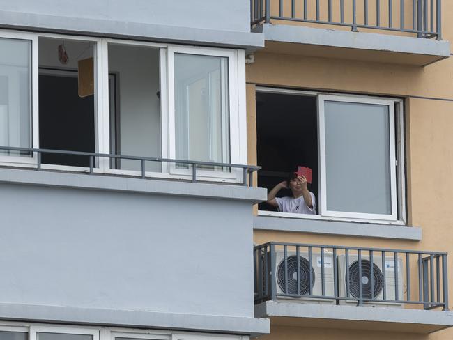 A woman takes selfie at a residential area in Shanghai during record Covid-19 cases and strict lockdown. Picture: Getty Images/Getty Images