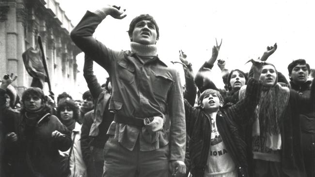 A large crowd of people outside the Communist Party Central Committee building in Bucharest observe a moment of silence for those murdered by Ceausescu's Securitate. Picture: Hedley Thomas