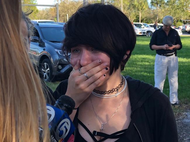 A student reacts as she talks to a television reporter at school. Picture: Michele Eve Sandberg/AFP