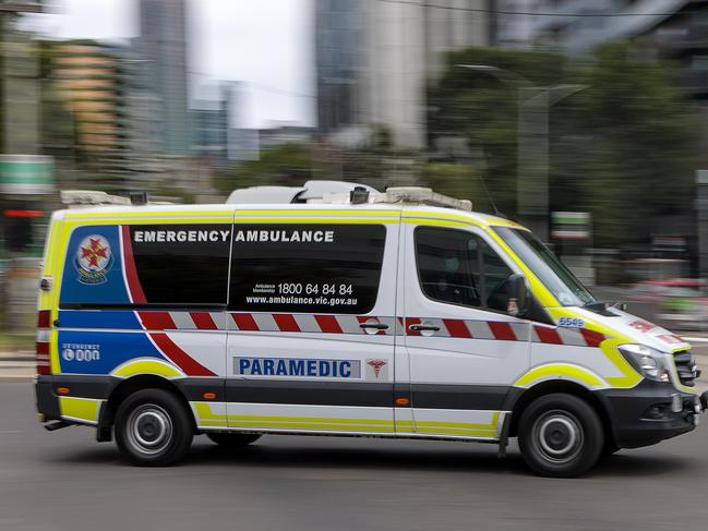 MELBOURNE, AUSTRALIA - NewsWire Photos FEBRUARY 13, 2022: An ambulance speeds away from the Royal Melbourne Hospital. Ambulance, Generic.Picture: NCA NewsWire / David Geraghty