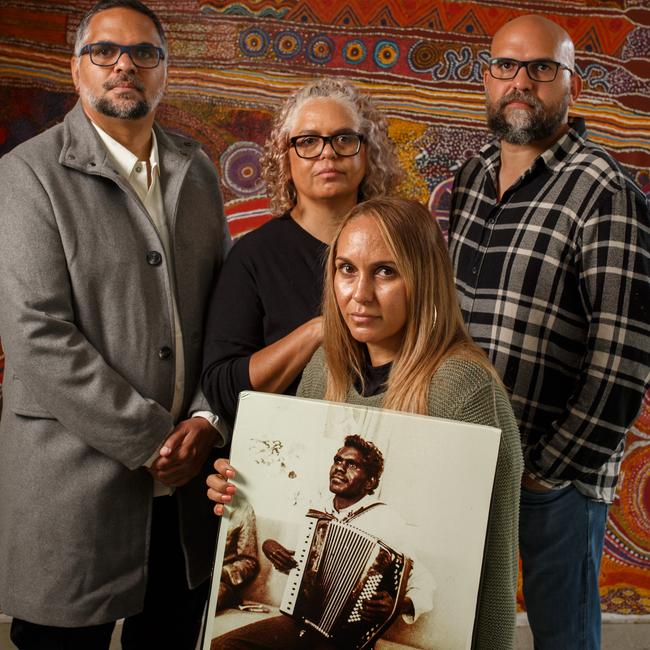 Joel Ken (left), Rebekah Osborne, Tjunkaya Ken and Aaron Ken with a photograph of their father, Kenneth Ken, who died in custody at Yatala Labor Prison. Picture: Matt Turner.