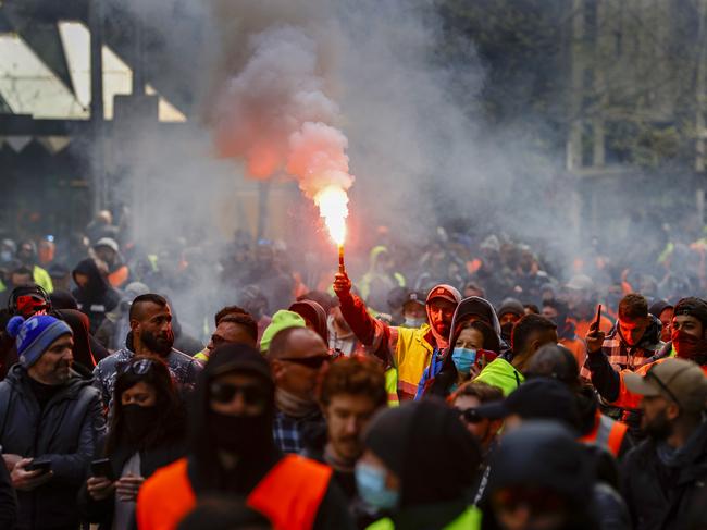 Flare are lit as the construction workers march through Melbourne’s CBD. Picture: Alex Coppel