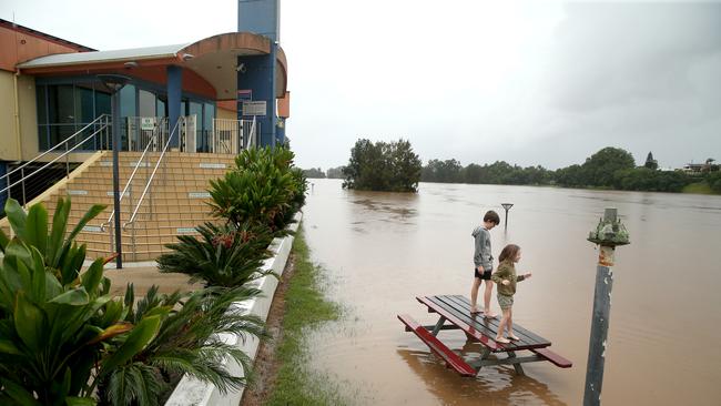 Heavy rain continues to batter the NSW mid north coast causing major flooding. Kempsey residents check the water levels at the towns levy wall. Nathan Edwards