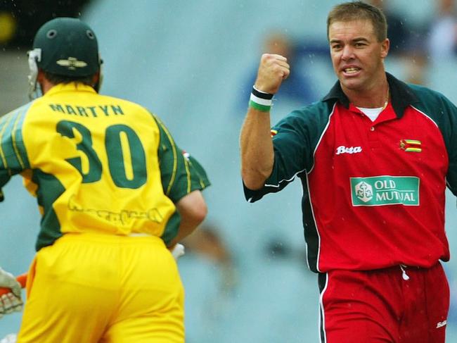 MELBOURNE, AUSTRALIA - JANUARY 29: Heath Streak of Zimbabwe celebrates the wicket of Damien Martyn of Australia during the VB Series One Day International between Australia and Zimbabwe at the MCG on January 29, 2004 in Melbourne, Australia. (Photo by Hamish Blair/Getty Images)