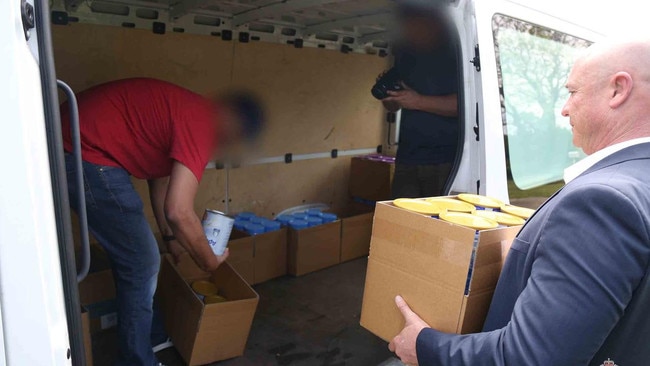 Three search warrants were executed as part of police investigations where a total of 1306 infant formula tins were recovered. Picture: NSW Police