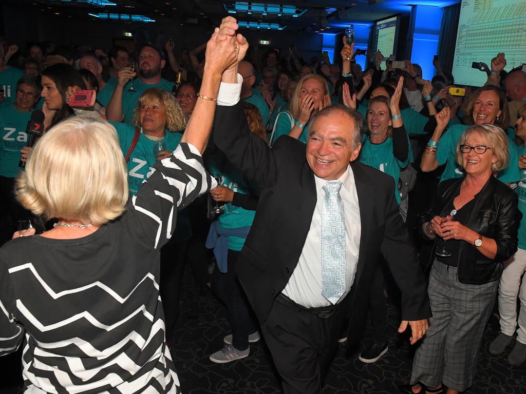 Zali Steggall’s supporters Rob Nercessian and Sue Rowlands danced as news dropped about Tony Abbott. Picture: AAP/Dylan Coker